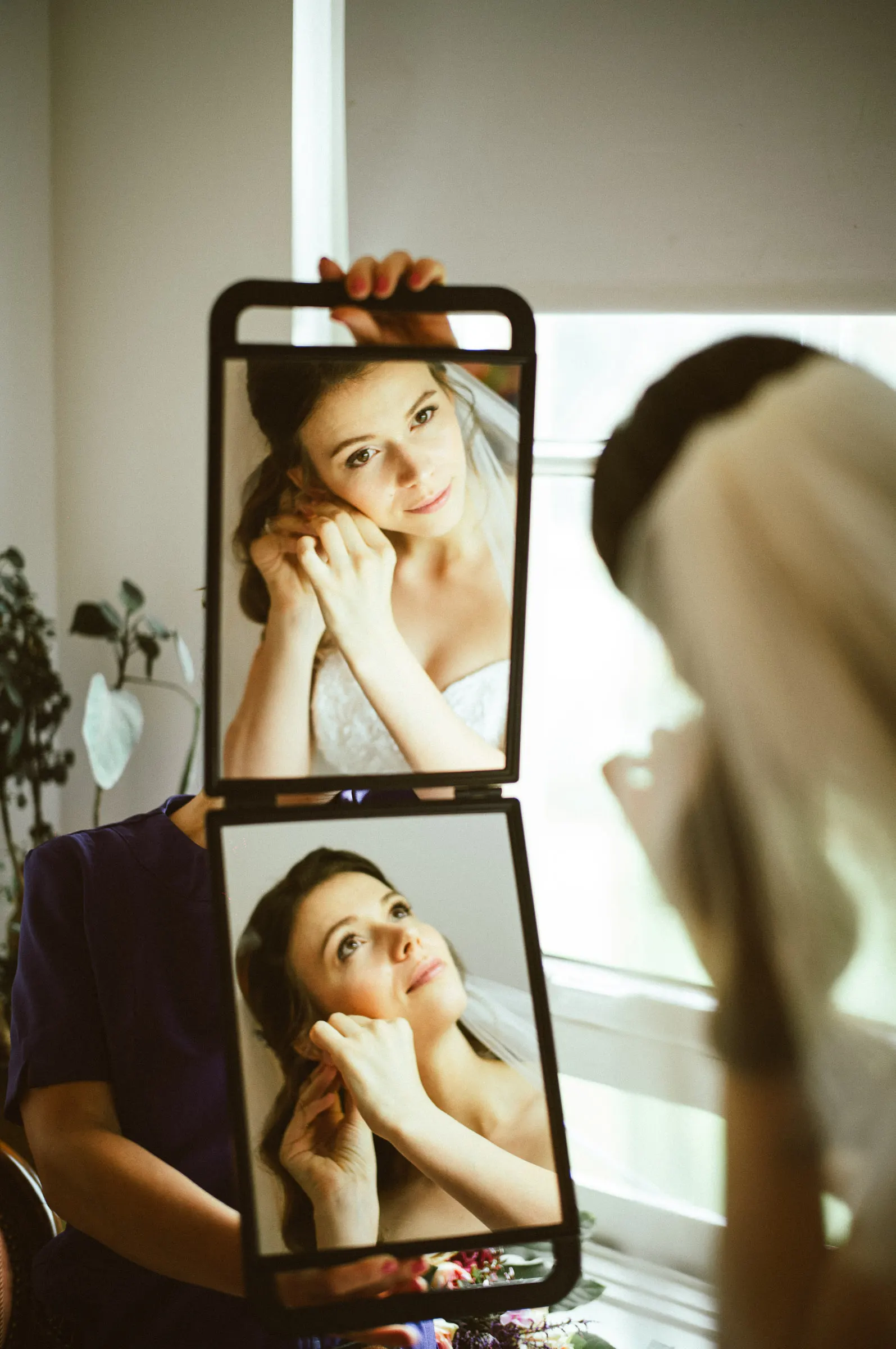 Cinematic portrait of a woman reflected in a three-panel mirror